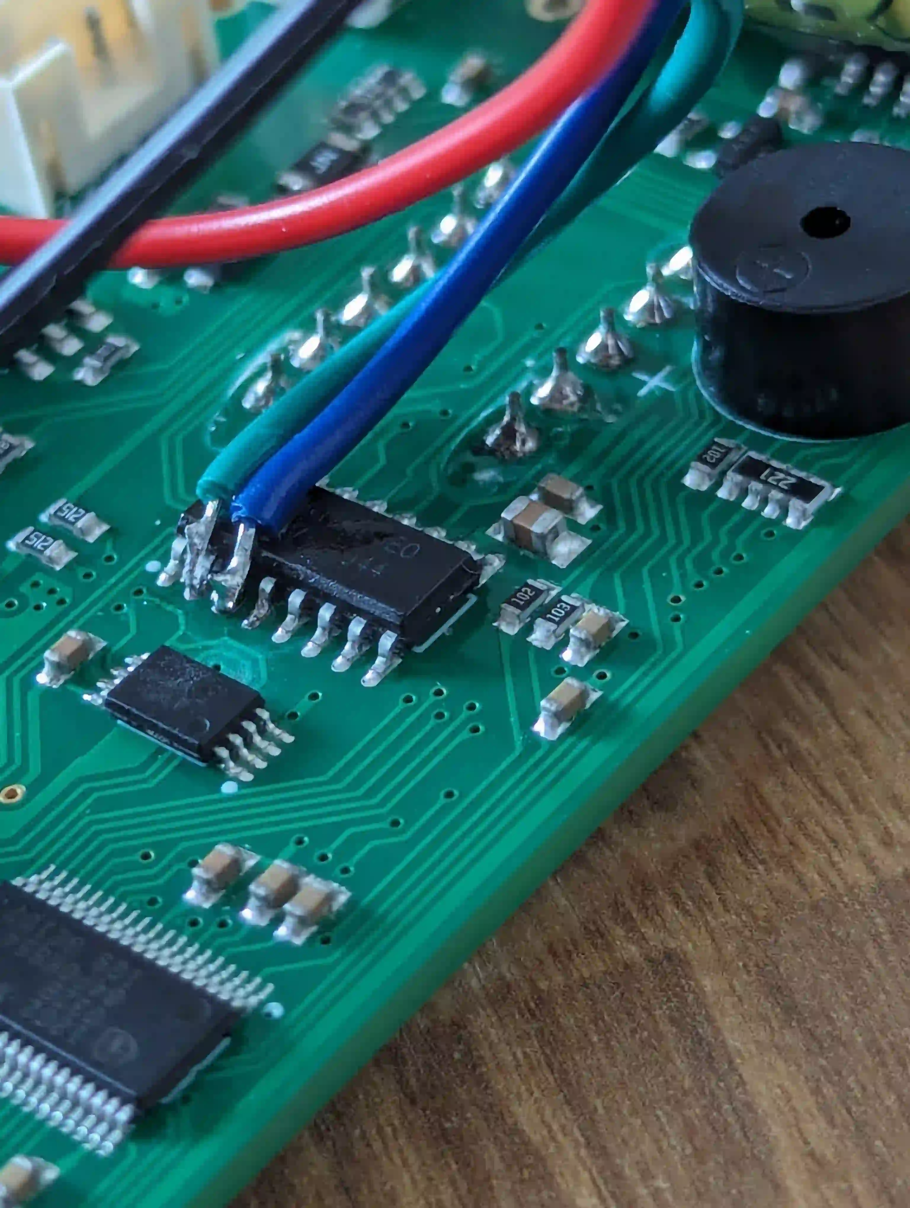 My terrible soldering to the SDA and SCL pins on the AiP650 chip